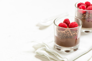 Chocolate dessert in glasses with raspberries