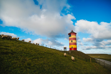 Pilsum Lighthouse on the North Sea in Germany. The red and yellow Lighthouse. 