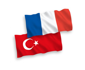 National vector fabric wave flags of Turkey and France isolated on white background. 1 to 2 proportion.