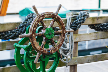Steering wheel on the ship. Wooden