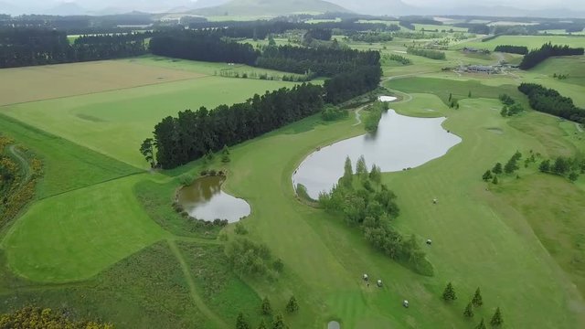 Aerial shot of large golf course with green lawn