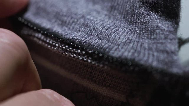Close up shot of a woman sewing.