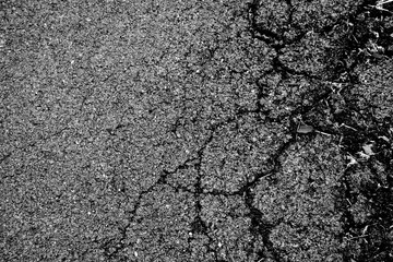 crack and texture of asphalt road - top view background.