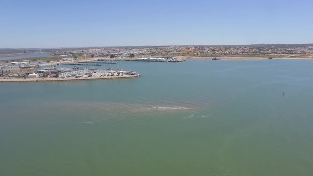 Aerial drone shot of a speadboat, near the pier.
