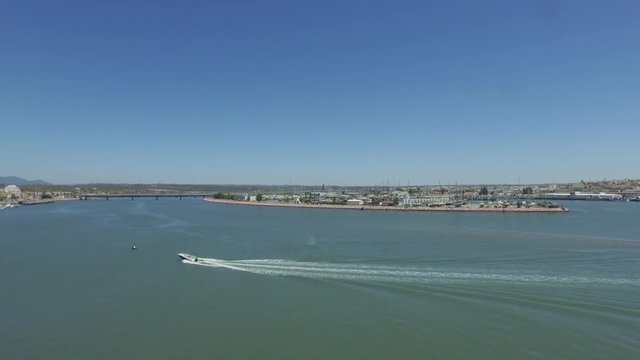 Aerial drone shot of a speadboat, near the pier.