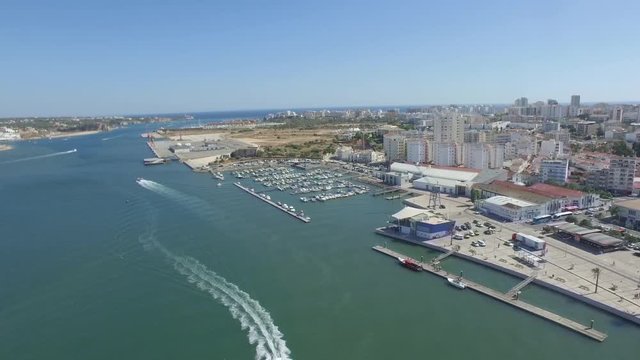 Aerial drone shot of speedboat, near the pier.