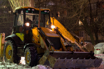 excavator snow cleaning night