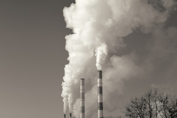 Stream of smoke from the chimney of factory. Toned image