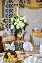 Wedding Reception Table Decor with Gold Accents and Flower Arrangements 