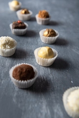 Fine chocolate candies on grey background. Close up