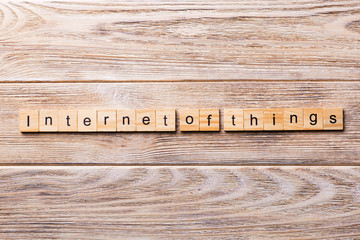 internet of things word written on wood block. IoT text on wooden table for your desing, concept
