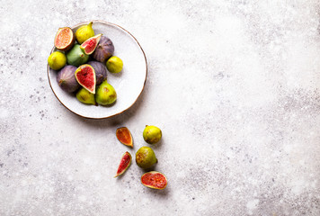 Fresh figs on plates. Berry on the stone Background.Fresh figs on plates. Berry on the stone Background.Healthy Food. Nutrition Concept.  Top View.Copy space for Text.