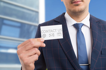 Salesman showing business card with communication services symbols.