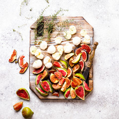 Ingredients for Salad Preparation. Figs Mozzarella Thyme and honey. The concept of food on a wooden board with a knife.Healthy Food.Nutrition Concept.