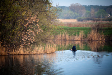 Fototapeta premium Fisherman in a boat on the river
