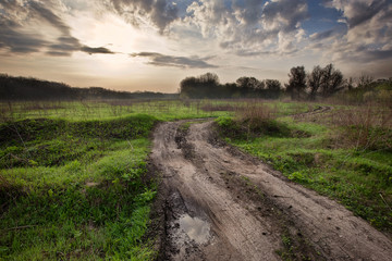 Fototapeta na wymiar Landscape with Dirt road to the sun