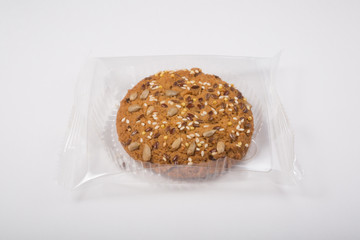 Oatmeal cookie in a plastic pack on a white