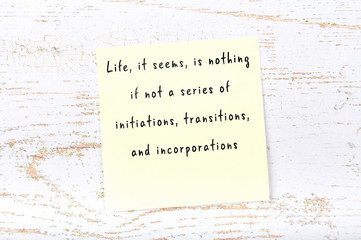 Positive inspiring quote handwritten on sticky note on wooden background