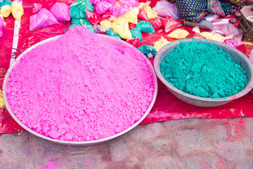Obraz na płótnie Canvas Bags of colored powdered paint sit waiting to be sold to Holi Festival celebrants