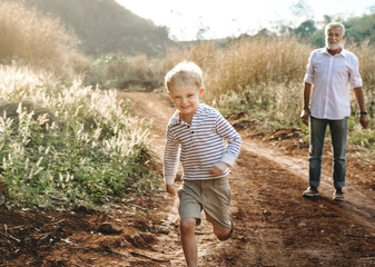Grandson and grandfather playing outdoors