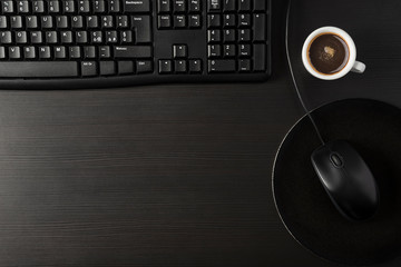 Total black desk with desktop and cup of coffee