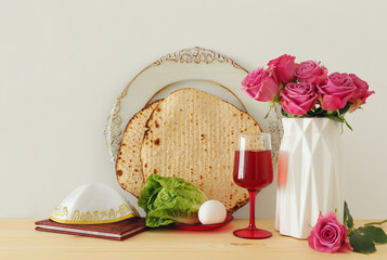 Pesah celebration concept (jewish Passover holiday) over wooden table.
