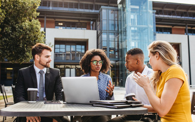 Group of business people at cafe discussing new project