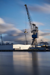 Fototapeta na wymiar Cranes at work loading and unloading ships at the Port of Rotterdam