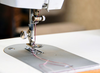 Sewing machine with needle and thread, closeup