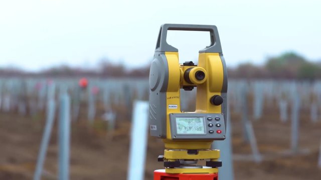 Close up of a total station on the field with blurred background