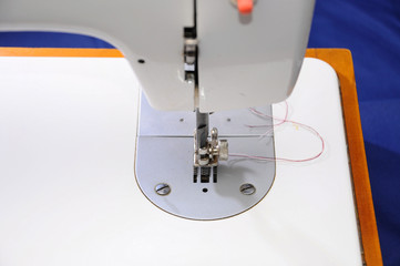 Sewing machine with needle and thread, close-up. blurred background