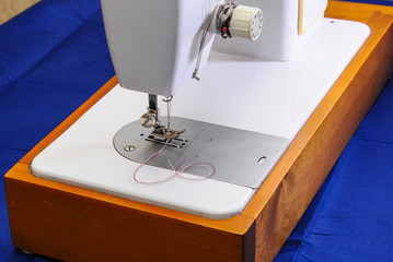 Sewing machine with needle and thread,close-up. blurred background