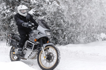 Rider man in action on adventure motorcycle. Winter fun. snowy day. ride on snow road. off road....