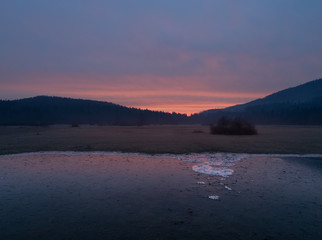 Frozen flooded field in Ribnica at golden hour