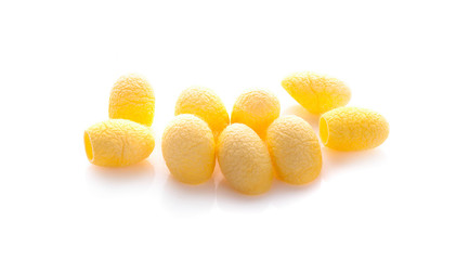 yellow thai silkworm cocoons pile isolated on white background.