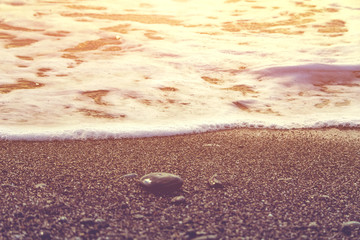 Purple pink beach. Sea shore. Stones on the coast. Calm