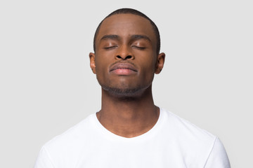 Calm mindful african american man enjoy taking deep breath