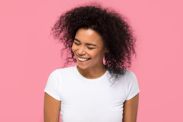 Happy african american girl laughing isolated on pink background