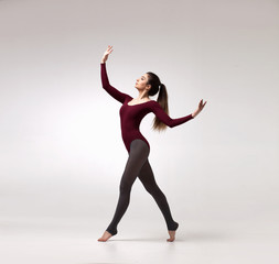 young beautiful dancer in beige swimsuit