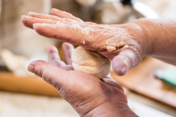 Chef pouring flour on wooden board.Selective focus.