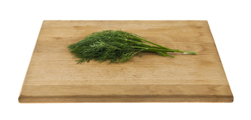 dill on a wooden board isolated on white background