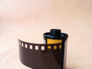close-up: old-fashioned photographic film for a camera on an orange background