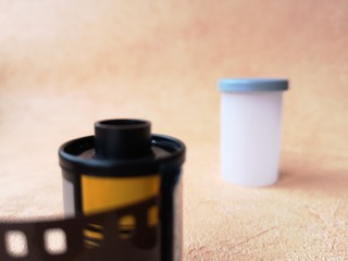 close-up: old-fashioned photographic film for a camera on an orange background