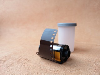 close-up: old-fashioned photographic film for a camera on an orange background