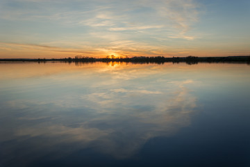 Sunset in the sun over a calm lake