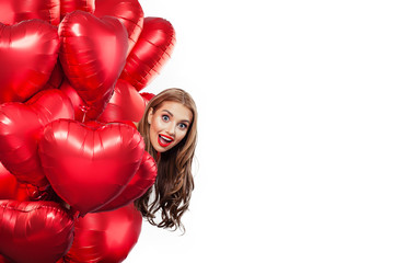 Excited young woman with balloons red heart isolated on white background. Surprised girl. Surprise, valentines people and Valentine's day concept