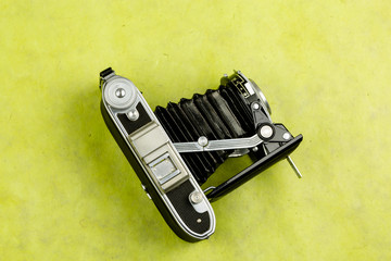 Top view of vintage camera on colorful background