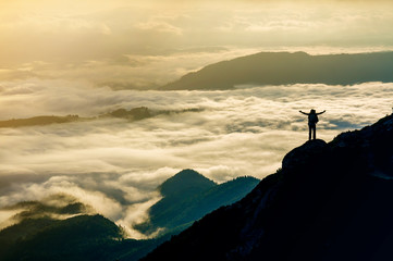 Wide mountain panorama. Small silhouette of tourist with backpack on rocky mountain slope with...