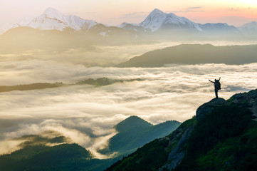 Wide mountain panorama. Small silhouette of tourist with backpack on rocky mountain slope with...