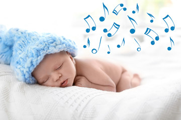 Cute newborn baby in knitted hat sleeping on bed and flying music notes. Lullaby song
